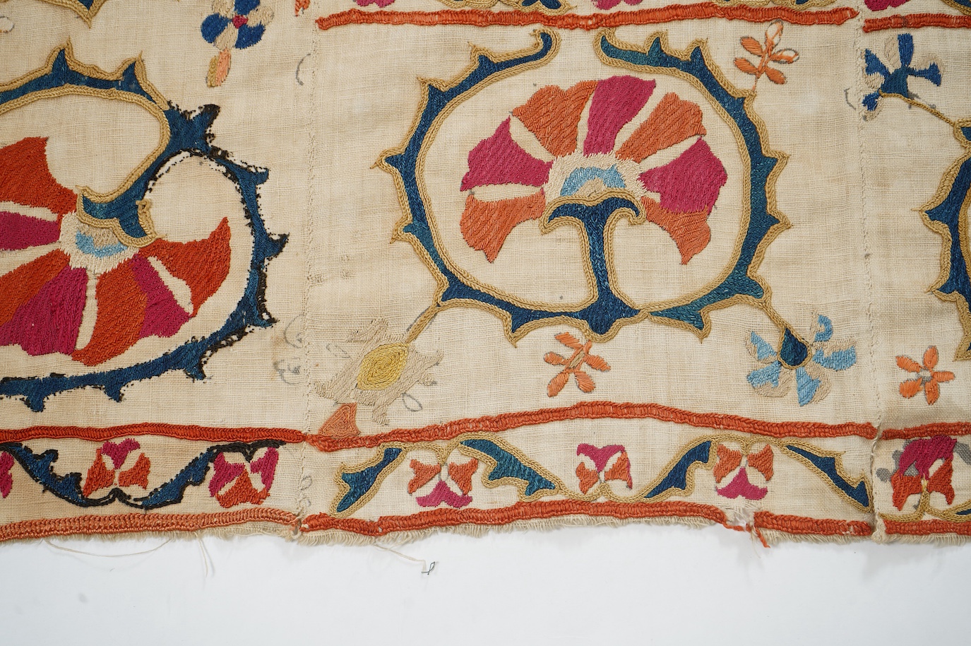 A 19th century Uzbekistan Suzani, hand embroidered hanging. Made from hand woven linen panels each approximately 28cm wide x 167cm long. Hand embroidered with silk hand dyed threads, in orange, red, blue and yellows, usi